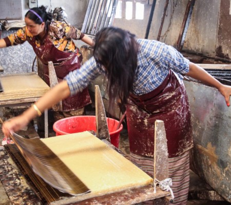 Two women making traditional bhutanese paper in paper factory near Thimphu in Bhutan